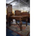 An Edwardian Oak Drawer Leaf Dining Table on Turned Bulbous Supports with Cross Stretcher, One
