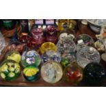 A Tray Containing Fifteen Glass Paperweights, Cranberry Glass Vase and Jug, Coloured Glass Bowls