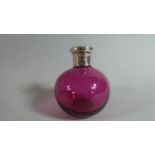 A Silver Topped Cranberry Glass Dressing Table Bottle, London 1920. 8cms High
