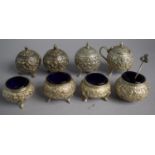 A Indian Silver Eight Piece Cruet Comprising Four Salts with Blue Glass Liners, Three Pepper Pots