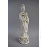 A Chinese Dehau Blanc De Chine Figure of Standing Guanyin with Lotus Flower, Restoration to Flower