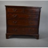 A Small Reproduction Crossbanded Mahogany Chest of Two Short and Three Long Drawers on Bracket Feet.