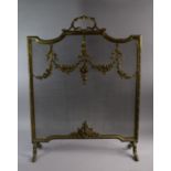 A French Brass and wire Fire Screen Decorated with Foliate Swags and Ribbons on Scrolled Feet,