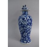 An Chinese Blue and White Vase and Cover with Prunus Decoration. Chip to Rim of Lid, 38cm high, Four