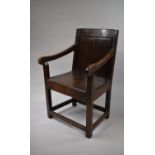 A 17th Century Oak Wainscot Arm Chair with a Fielded Panel Back, Down Swept Arms and Plank Seat over