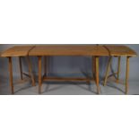 A 1970's Ercol Elm and Beech Dining Table with Two Extensions Pieces on Tapering Supports