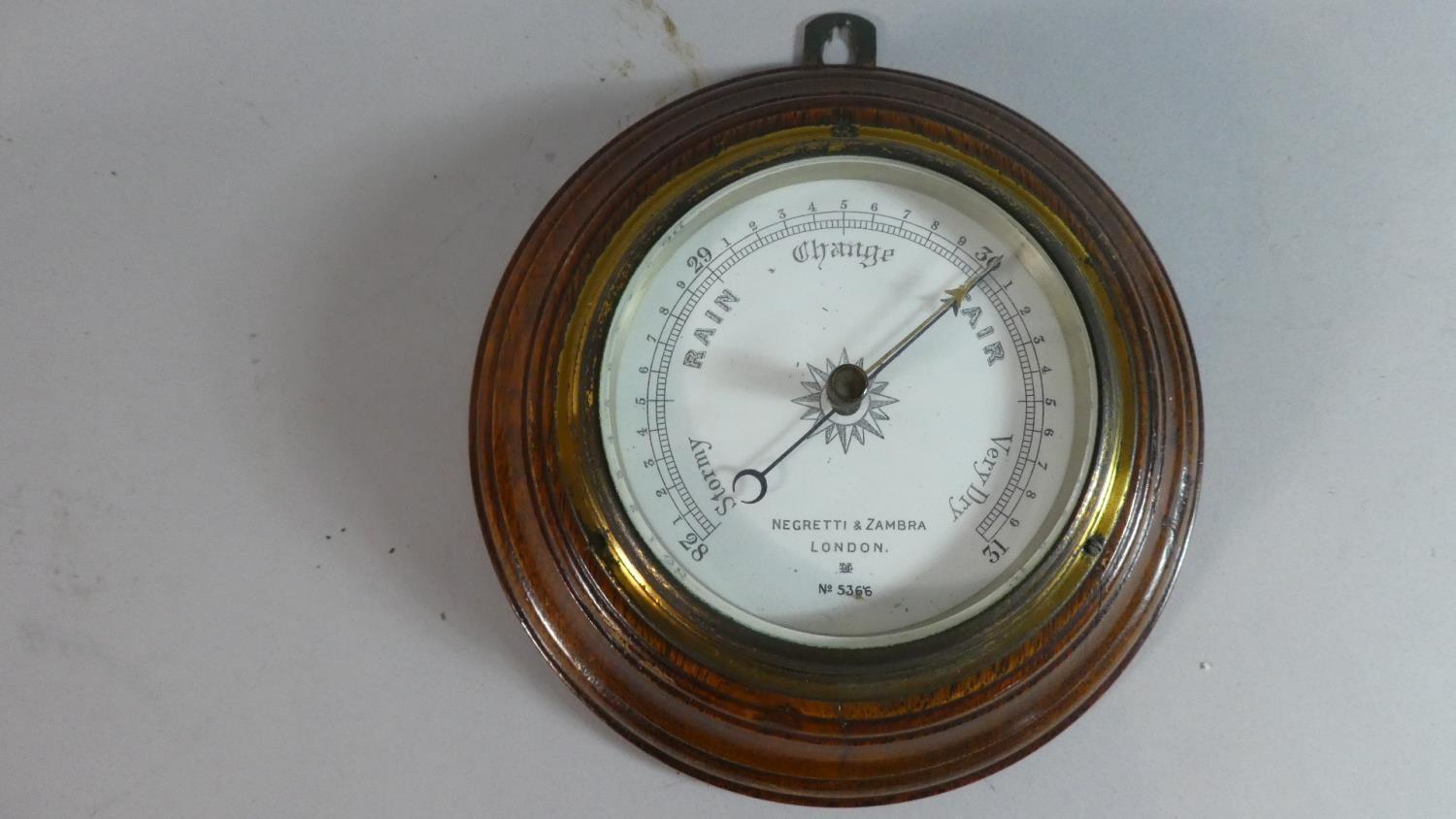 An Edwardian Circular Oak Framed Aneroid Barometer by Negretti & Zambra, No.5366