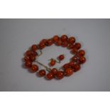 An Early 20th Century Carnelian Bead Necklace and Matching Earrings, on Gold Metal Extendable Chain,