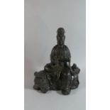 A Chinese Bronze Study of Guanyin Seated Upon Temple Dog. Seal Mark to Base, 28cms High