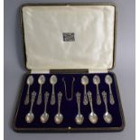 A Cased Set of Twelve Silver Coffee Spoons with Pierced Handles and a Matching Sugar Bow,