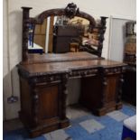A Late 19th Century Carved Oak Mirror Back Sideboard with Inverted Breakfront Carved King and