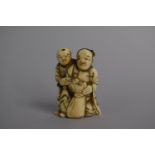 A 19th Century Oriental Ivory Netsuke in the Form of Farmers with Sack, 4.5cm high