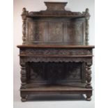 A 19th Century Carved Oak Panelled and Glazed Two Tier Buffet with Two Centre Drawers and Raised