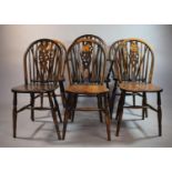 A Set of Six Oak Wheel Back Dining Chairs to Include One Carver