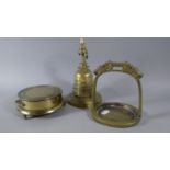 A Brass Oriental Novelty Stand in the Form of a Stirrup Together with a Brass Temple Ornament