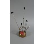 A Vintage Metal Pin Cushion containing Various Hat Pins, Enamelled Canada Pin Etc