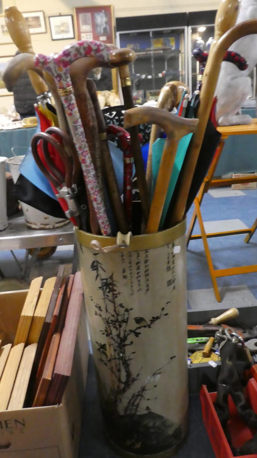 A Cylindrical Stick Stand with Oriental Decoration Containing Large Quantity of Walking Sticks and