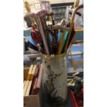 A Cylindrical Stick Stand with Oriental Decoration Containing Large Quantity of Walking Sticks and