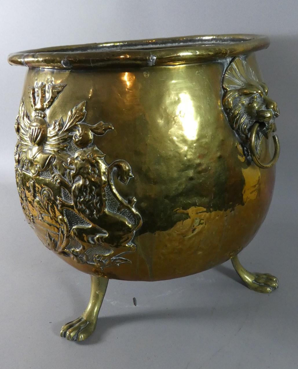 A Large Brass Coal Bucket with Lion Mask and Ring Carrying Handles and Armorial Decoration in