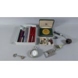 A Box of Sundries to Include Ball Point Pens, Vintage Pipe, Medallion Etc