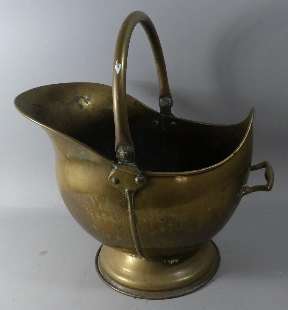 A Brass Helmet Shaped Coal Scuttle, 45cm High