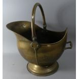 A Brass Helmet Shaped Coal Scuttle, 45cm High