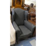 An Edwardian Re-Upholstered Mahogany Framed Wing Armchair with Claw and Ball Feet