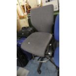 A Swivel Rise and Fall Office Chair and a Small Circular table