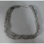 A Silver and Moonstone Three Strand Necklace