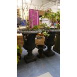 A Pair of Cast Iron Vase Shaped Patio Planters and a Miniature Example, 61cm high