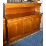 A Modern Dining Room Buffet Sideboard with Panelled Doors to Three Cupboard Base and Raised