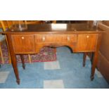 A Mahogany Side Table with Centre Drawer Flanked by Two Cupboards on Square Tapering Legs on Spade