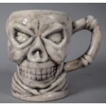 A Novelty Mug in the Form of a Skull, 12cm High