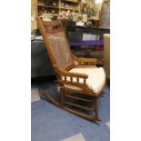 A Cane Backed Rocking Chair