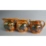 A Graduated Set of Three Bursley "Dragon" Pattern Lustre Jugs (Designed by Frank Rhead) (One with