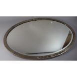 A Late 19th Century Arts and Crafts Influenced Art Nouveau Silver Plate on Brass Framed Oval Wall