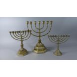 A Collection of Three 20th Century Brass Menorahs, the Tallest, 34cm High