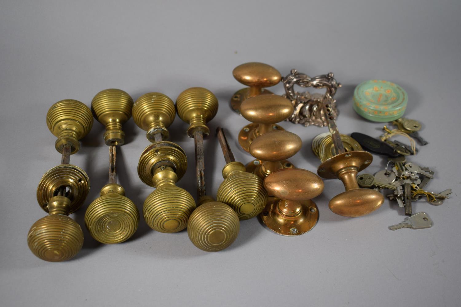 A Collection of Various Late 19th Century Brass Door Knobs and Handles.