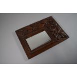 A Small Carved Oak Mirror Decorated in Relief with Flowers. 22.5cm x 30.5cm Overall.