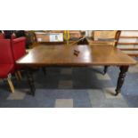 An Edwardian Wind Out Mahogany Dining Table on Turned Supports with Casters, Complete with One Extra