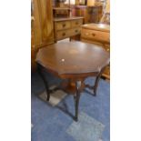 An Edwardian Inlaid Mahogany Octagonal Table with Stretcher Shelf.