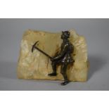 A Patinated Bronze Black Forest Paperweight in the Form of Early Mountaineer with Ice Axe Set on