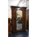 A Late Victorian Mirror Fronted Wardrobe with Hinged Doors to Hanging Section and Section with Three