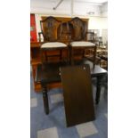 An Extending Oak Dining Table with Extra Leaf on Turned Supports with Pair of Shield Back Carver