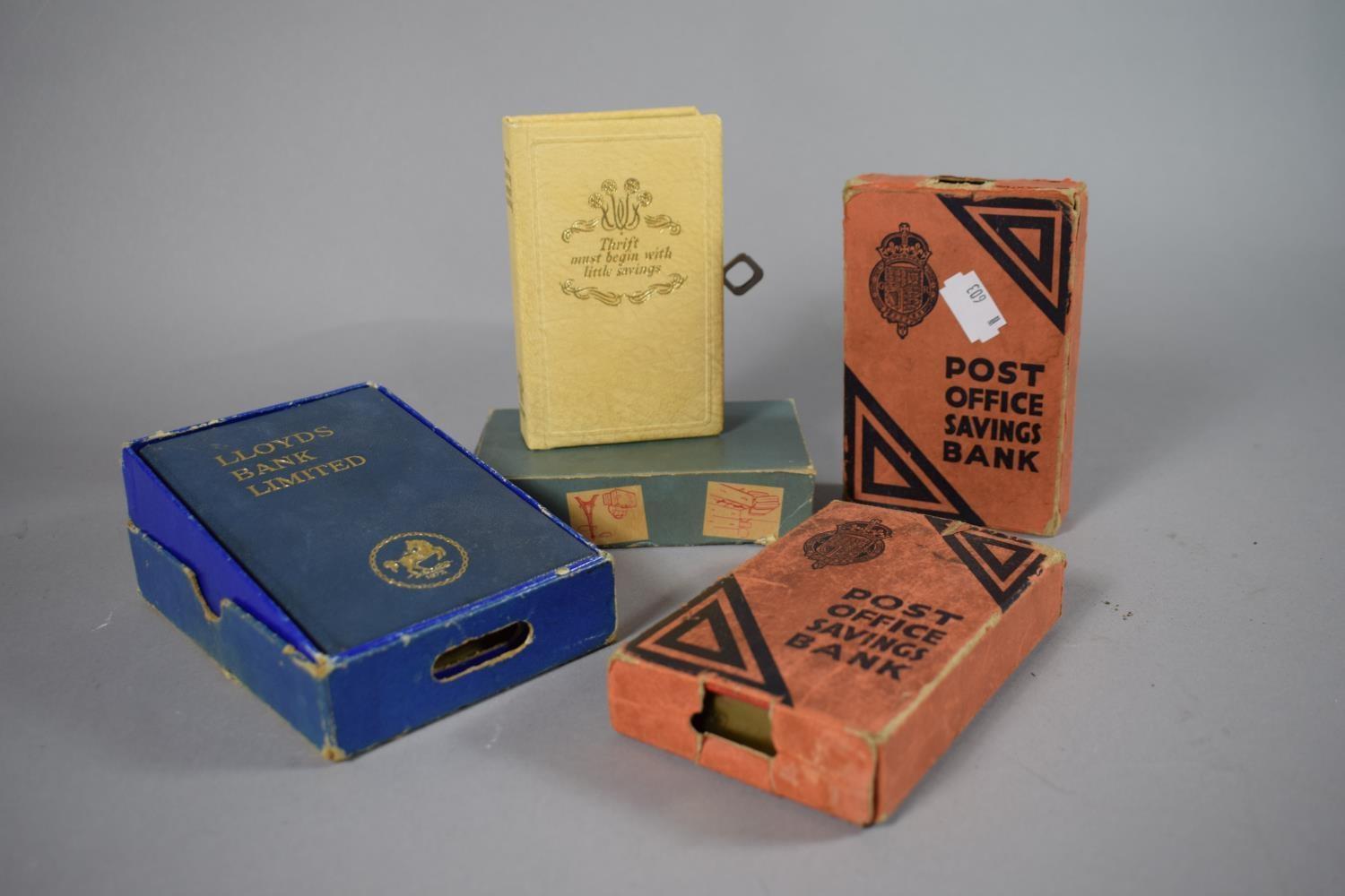 A Collection of Four Vintage Savings Boxes with Cardboard Sleeves and One Key.