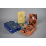 A Collection of Four Vintage Savings Boxes with Cardboard Sleeves and One Key.
