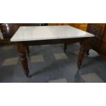 A Late Victorian/Edwardian Former Wind-out Dining Table with Reeded Legs. Now Having Formica Top,