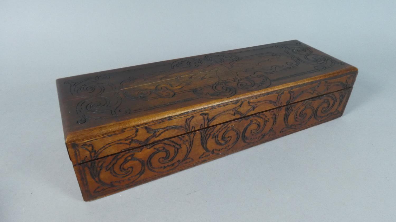 A Decorated Wooden Glove Box, the Hinged Lid with Poker Work Dragon and Snake, the Base Inscribed