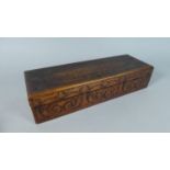 A Decorated Wooden Glove Box, the Hinged Lid with Poker Work Dragon and Snake, the Base Inscribed