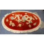 An Oval Chinese Deep Pile "Dragon and Pearl" Rug, 170cm x 96cm